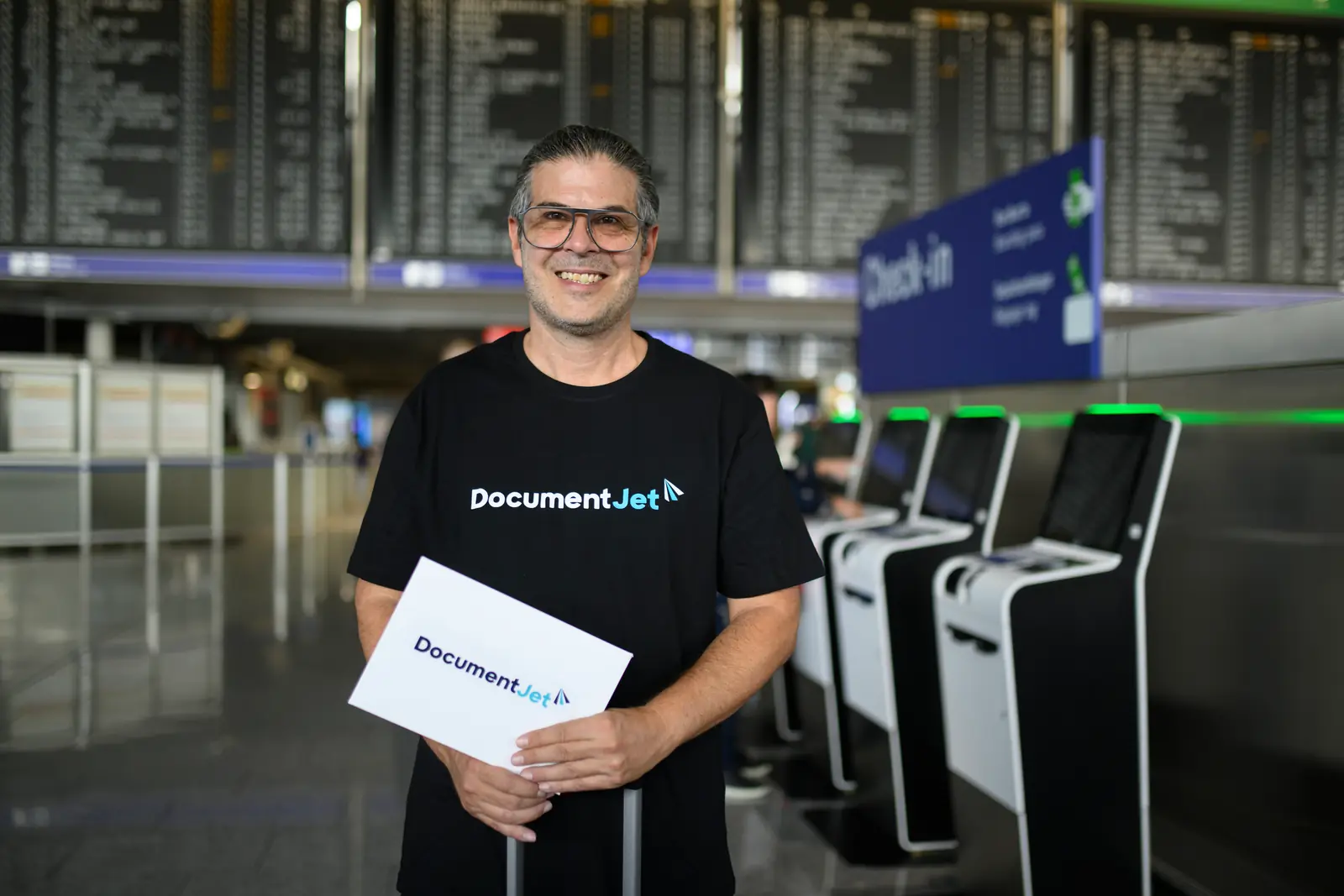 DocumentJet flight courier holding a document envelope at airport check-in